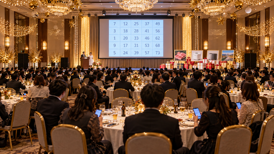 大人数の忘年会でビンゴ大会が行われている宴会場
