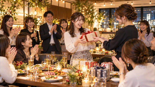 女性が多い職場の忘年会で景品を受け取る女性社員と拍手する同僚たち